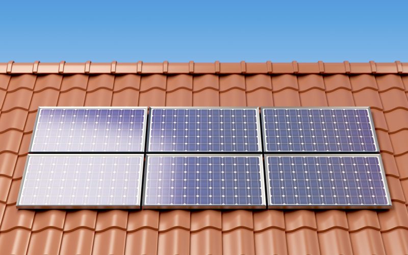 Solar panels on the roof of a house, producing electricity